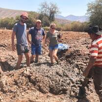 3 students preparing the mud to make adobe bricks