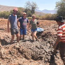 3 students preparing the mud to make adobe bricks