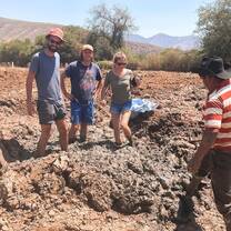 3 students preparing the mud to make adobe bricks