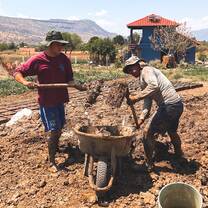 Student helping with the adobe brick making