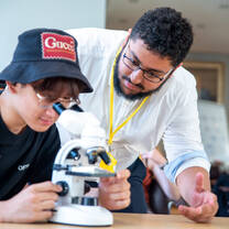 Lecturer looking at cells with student