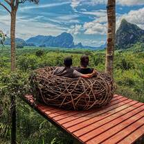 two teachers sit in a nest chair at a viewpoint in Northern Thailand