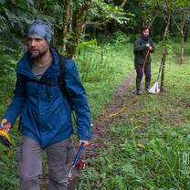 Two field team members setting up a survey in the cloud forest
