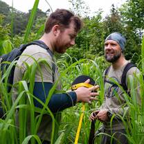 Two field team members setting up a survey in the cloud forest