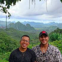 Two teachers stand smiling at a viewpoint in Northern Thailand 