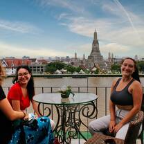 A group of teachers sit in a cafe opposite Wat Arun in Bangkok 