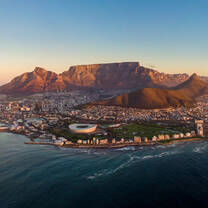 Panoramic view of Cape Town at sunset with Table Mountain and the Cape Peninsula mountains in the background