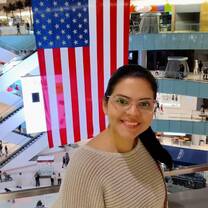 Teacher in front of a US Flag