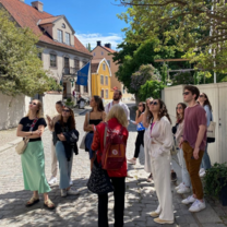 Some students are standing in a street and looking up
