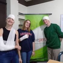 Volunteers pose for a picture after a medical skills class focused on bandages and splints.