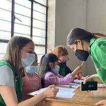 Volunteers working with local children in an after school English workshop.