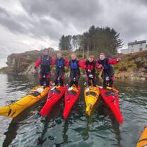 padlers standing in kayaks