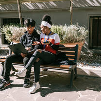 2 students sitting on a bench