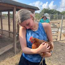 girl holding a chicken