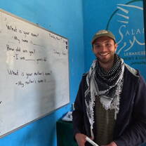Teacher standing by a whiteboard