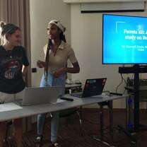 two girls giving a presentation on ferrets