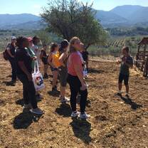 group of students standing on a farm listening to a speaker