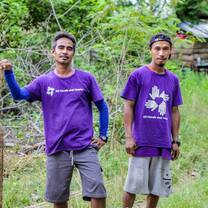 two volunteers in the Philippines standing in grassy field