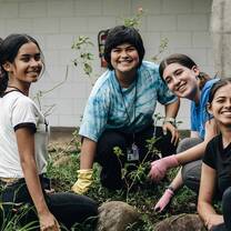 Five students gardening in Costa Rica
