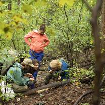 An instructor shows students how to find identify wild edibles. 