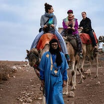 Students on a camel trek led by local guide