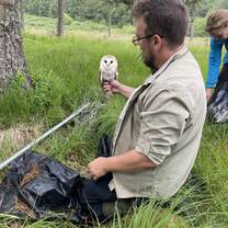 Student caring for an owl during an ecology internship abroad, gaining hands-on wildlife conservation experience