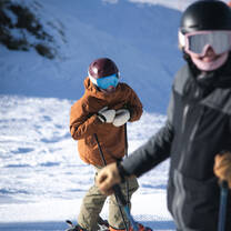 Women smiling at camera while skiing