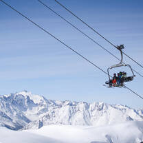 Course participants sitting on chairlift