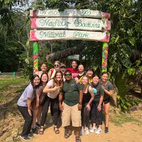 Group photo in front of a sign