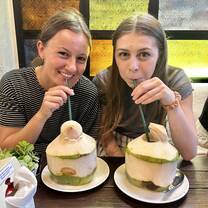Two participants eating coconuts