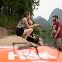 Students studying by the river