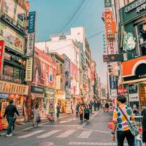 A busy street scene with colorful buildings and signs