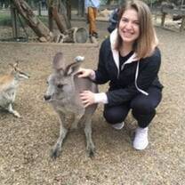 CEA CAPA Student kneels down next to kangaroo