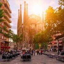 Sagrada Familia in front of sun in Barcelona, Spain