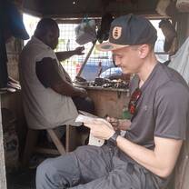 Social work volunteer working with person with disability. (cobbler)