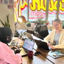 Three people working on laptops.