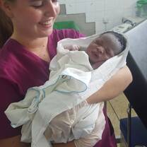 Midwife nurse with a newly born baby
