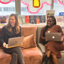 Two woman working with laptops