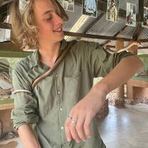 Intern with snake wrapped around him