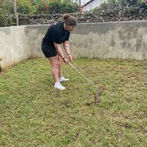 Intern using snake tongs to catch a snake 