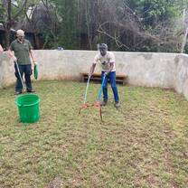 Intern catching a snake to put in a bucket