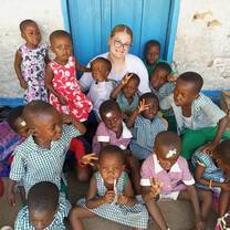 Childcare volunteer with children at James Town Gbekebii school in Accra