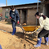 Volunteers with a wheelbarrow