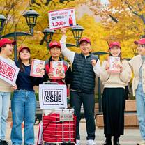Group photo holding The Big Issue brochures