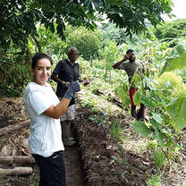 Group standing in vegetable garden 