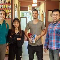 four young people standing at a chinese school