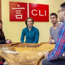 four young people sitting at a tea table at a chinese school