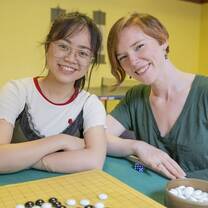 two young friends sitting at a go board