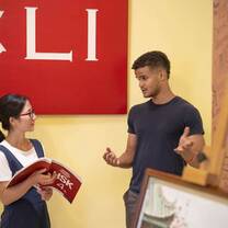 student and chinese teacher chatting