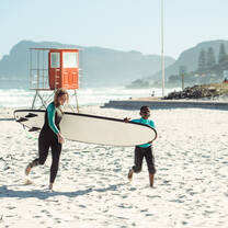 Volunteer Eline helping during a surf session.